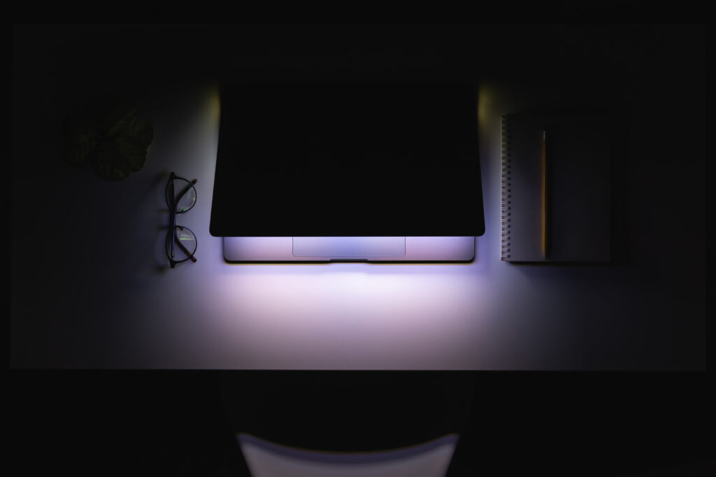 laptop in the dark at night on the desktop.